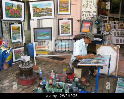 Un artista al lavoro nella città di Malacca, nello stato di Malacca, in Malesia. Foto Stock