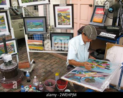 Un artista al lavoro nella città di Malacca, nello stato di Malacca, in Malesia. Foto Stock