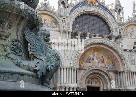 Antico ornamento di strada con leoni alati e basilica di San Marco sullo sfondo, in San Piazza Marco, famosa attrazione turistica a Venezia, Italia. Foto Stock