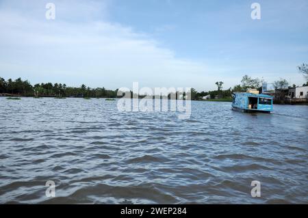 CAI RANG, VIETNAM - 17 FEBBRAIO 2013: Persone che viaggiano e lavorano con le loro barche di legno nel delta del Mekong dove il trasporto è possibile solo su b Foto Stock