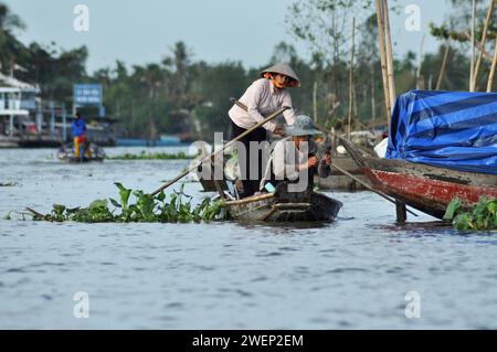 CAI RANG, VIETNAM - 17 FEBBRAIO 2013: Persone che viaggiano e lavorano con le loro barche di legno nel delta del Mekong dove il trasporto è possibile solo su b Foto Stock