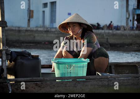 CAI RANG, VIETNAM - 17 FEBBRAIO 2013: Persone che viaggiano e lavorano con le loro barche di legno nel delta del Mekong dove il trasporto è possibile solo su b Foto Stock