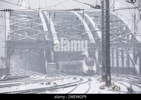 Treno National Express proveniente dal ponte Hohenzollern e diretto verso la stazione centrale, neve, nevicate, Colonia, Germania. 17 gennaio. 2024 Nationa Foto Stock