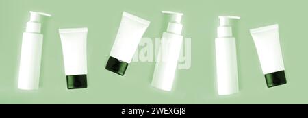 Flaconi e provette di prodotti per la cura del corpo bianchi su sfondo verde. Cura della pelle e concetto di bellezza Foto Stock