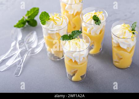 Parfait di meringa al limone in tazze piccole con torta libbre e panna montata Foto Stock