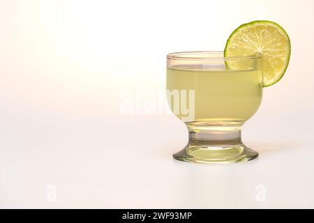 pisco sour con limone su sfondo bianco Foto Stock