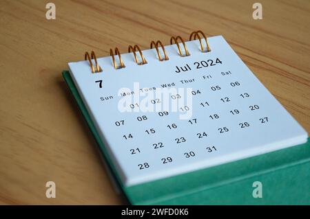 Vista ravvicinata del calendario di luglio 2024 su una scrivania di legno. Concetto di calendario. Foto Stock