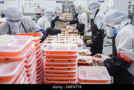 (240131) -- WUHAN, 31 gennaio 2024 (Xinhua) -- i membri del personale si preparano per i pasti al sacco presso una base di catering ferroviaria a Wuhan, nella provincia di Hubei della Cina centrale, 30 gennaio 2024. Dotata di una moderna linea di produzione di pasti al sacco, la base di catering ferroviaria si è occupata di fornire pasti al sacco per i treni ad alta velocità sotto la gestione della China Railway Wuhan Bureau Group Co., Ltd Durante la corsa di quest'anno al Festival di primavera, iniziata il 26 gennaio, la China Railway Wuhan Bureau Group Co., Ltd. Ha lanciato quattro nuovi piatti con sapori locali di Wuhan. Pasti al sacco con prelibatezze locali Foto Stock