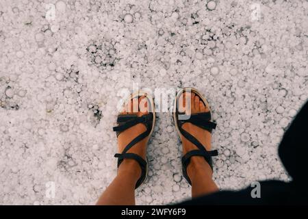 gambe nello spesso strato di grandine sul terreno. Foto di alta qualità Foto Stock