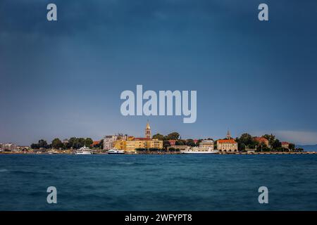 Zara, Croazia - Vista panoramica della città vecchia di Zara al tramonto con la Cattedrale illuminata di San Anastasia campanile, yacht e traghetto e chiaro Foto Stock