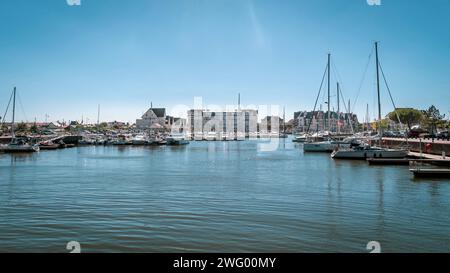 Diverse piccole barche attraccate in una baia con un edificio nelle vicinanze Foto Stock