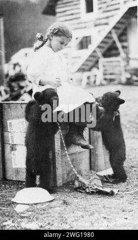 Ragazza con cuccioli d'orso, tra c1900 e c1930. Foto Stock