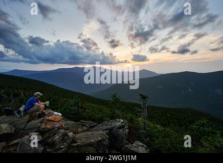 Escursionista godendo la vista del monte Galehead al tramonto, della White Mountain National Forest, New Hampshire, Stati Uniti Foto Stock