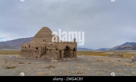 Vista panoramica delle rovine dell'antica strada della seta caravanserraglio o tomba cinese tra le montagne di Bash Gumbaz, Gorno-Badakshan, Tagikistan Pamir Foto Stock