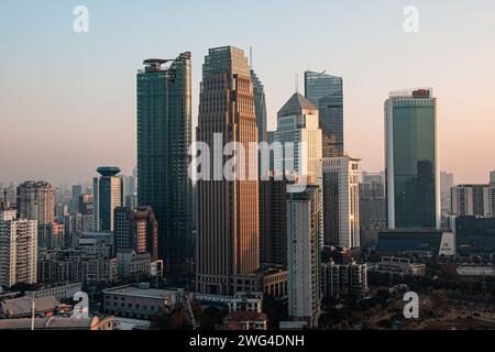 Una vista panoramica dei grattacieli nel quartiere finanziario di Wuhan, in Cina al tramonto Foto Stock