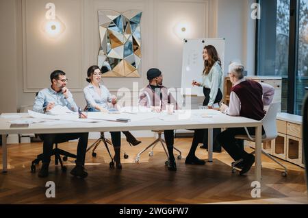 Colleghi multirazziali impegnati in una riunione strategica in un ufficio moderno. Foto Stock