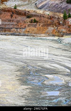 Formazioni rocciose naturalmente striate con tracce di acqua acida blu-verde nella regione del Rio Tinto Foto Stock