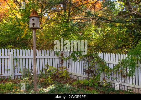 An inviting bench sits in front of the side yard Foto Stock