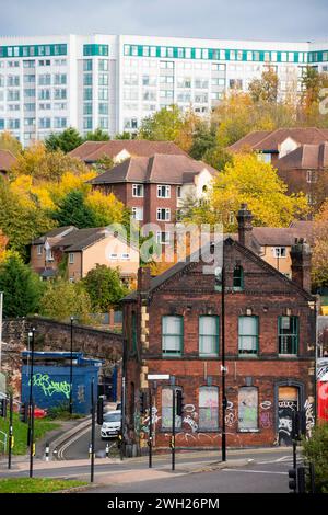 Sheffield, Regno Unito – 13 novembre 2021: Il derelict si è imbarcato sul Best Fit Tyre Centre con nuove case e appartamenti alle spalle, il paesaggio urbano di Sheffield vecchio e nuovo Foto Stock