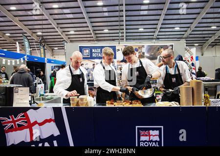 Gli chef della Royal Navy cucinano dal vivo alla fiera Source Food, drink, catering e ospitalità che si tiene a Westpoint Exeter Regno Unito, con espositori e marchi il 7 febbraio 2024 Foto Stock
