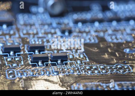 Macro shot dei componenti della scheda madre con chip transistor. Il chipset della scheda madre coordina la comunicazione tra i dispositivi hardware del computer. Foto Stock