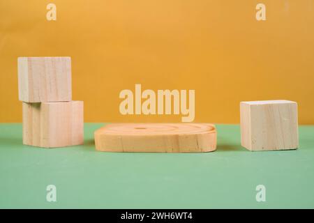 Podio a cubetti di legno su sfondo giallo. Vetrina per prodotti cosmetici. Pubblicità sui prodotti. Visualizzazione stile layout. Foto Stock