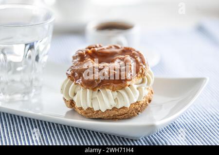 Veternik - ciambella dolce, tipica torta dolce slovacca al caramello con ripieno di panna ricoperta di caramello su un piatto in un caffè. Foto Stock