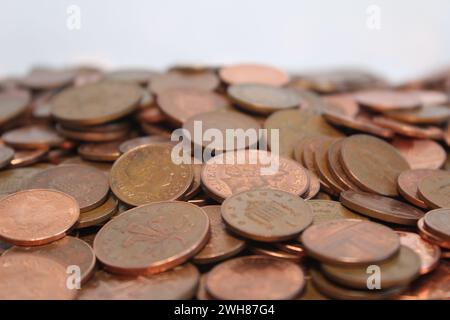Le monete da uno e due pence britanniche si diffondono contro un fondo bianco Foto Stock