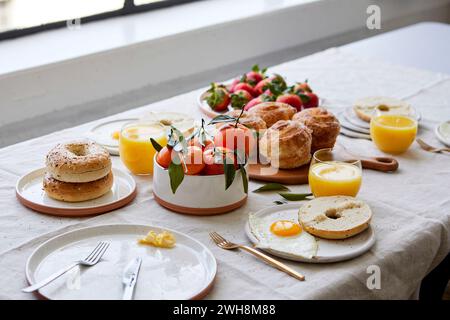 Colazione Tablescape con pasticcini, succo d'arancia e frutta Foto Stock