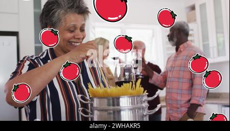 Immagine delle icone del pomodoro su diversi gruppi di anziani che cucinano Foto Stock