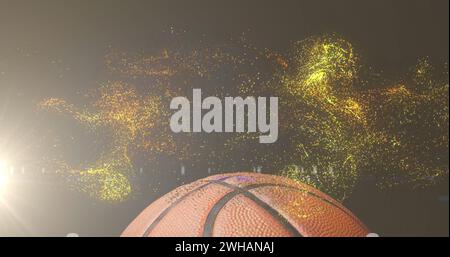 Immagine di particelle d'oro incandescenti che si muovono sul basket Foto Stock