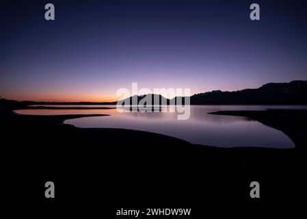 Colorata alba sul Forggensee parzialmente drenato vicino a Füssen in inverno. Forggensee, Füssen, Schwangau, Ostallgäu, Allgäu, Baviera, Germania meridionale, Germania Foto Stock