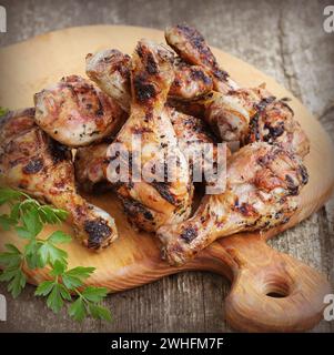 Pollo alla griglia gambe sul bordo di taglio.cena rustica sfondo Foto Stock