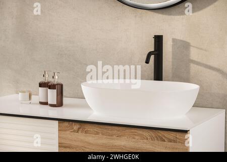 Primo piano del lavandino con specchio ovale in piedi su una parete beige, armadio bianco con rubinetto nero nel bagno minimalista Foto Stock