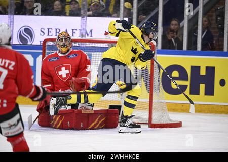 KARLSTAD, SVEZIA 20240210Joakim Nygard svedese (R) segna il gol di apertura al portiere svizzero Stéphane Charlin durante i Beijer Hockey Games (Euro Foto Stock