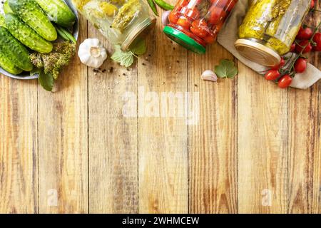 Cetrioli sottaceto salati e pomodori conservati in scatola in vaso di vetro. Economia domestica, conservazione del raccolto autunnale. Omema sano Foto Stock