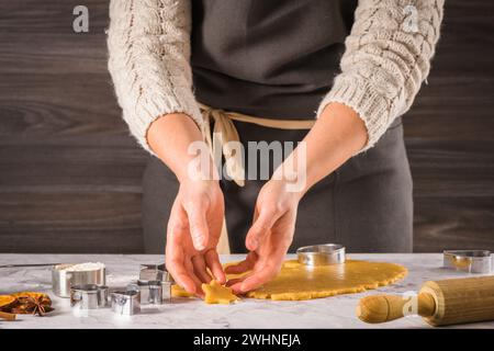 Mani femminili che preparano biscotti di Natale Foto Stock