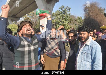 11 febbraio 2024, Rawalpindi, Punjab, Pakistan: Sostenitori del partito Tehreek-e-Insaf (PTI) in Pakistan cantano slogan durante una protesta al di fuori di un ufficio elettorale a Rawalpindi l'11 febbraio 2024, tra le affermazioni secondo cui i ritardi nei risultati elettorali stanno permettendo ai funzionari di manipolare il conteggio dei voti. La polizia pakistana ha avvertito domenica che avrebbero represso gli incontri illegali dopo che il partito dell'ex primo ministro Imran Khan, imprigionato, ha fatto appello ai sostenitori per protestare contro i presunti trucchi delle elezioni della scorsa settimana. (Credit Image: © Raja Imran Bahader/Pacific Press via ZUMA Press Wire) SOLO PER USO EDITORIALE! Non f Foto Stock