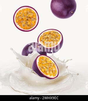 Frutti della passione che cadono nel latte con schizzi Foto Stock