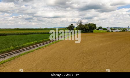 Veduta aerea dell'America rurale, con Farmlands e un Single Rail Road Track Thru IT Foto Stock