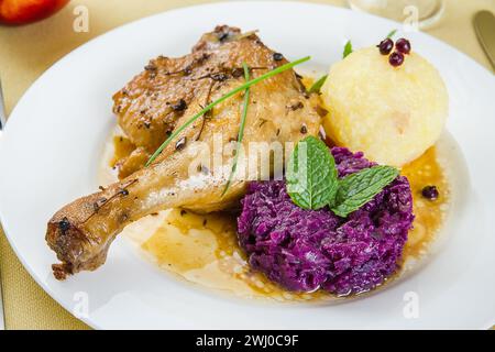 Zampa d'anatra, gnocchi di patate, cavolo rosso Foto Stock