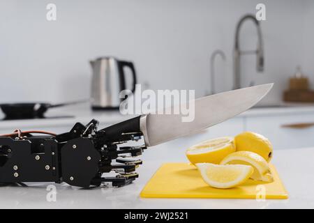 La mano del vero robot che taglia i limoni con un coltello affilato. Concetto di automazione robotica dei processi Foto Stock