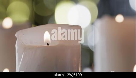 Immagine del testo dei saluti delle stagioni sullo sfondo delle candele accese Foto Stock