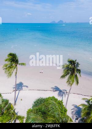 Vista del drone di Koh Mook con una coppia che cammina sulla spiaggia tropicale di sabbia bianca di Koh MukThailand Foto Stock