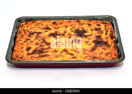 Una torta al forno è su una teglia da forno. La torta è cotta con formaggio fresco e zucca. Foto Stock