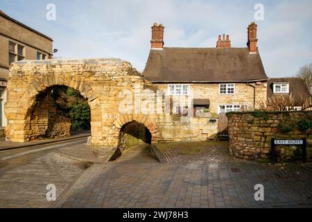 Il Newport Arch e la strada che porta a Bailgate, l'area superiore di Lincoln. Newport Arch è una porta romana del III secolo nella città di Lincoln, nel Lincolnshire. Si tratta di un monumento e di un edificio classificato di grado i ed è considerato l'arco più antico del Regno Unito ancora utilizzato dal traffico. Foto Stock