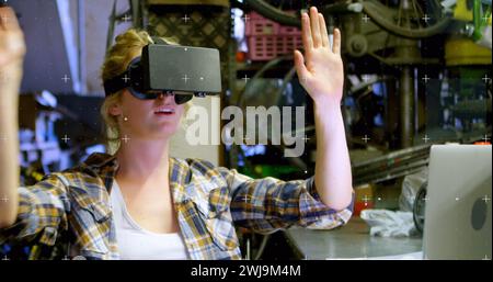 Immagine di marcatori bianchi che si muovono sopra una donna che indossa il visore vr e che muove le mani Foto Stock