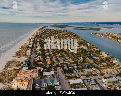 Uno scatto aereo cattura le tranquille strade e le proprietà sul lungomare di un quartiere di Miami accanto a una vasta spiaggia di sabbia. Foto Stock