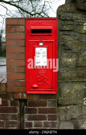 Kearsley Manchester gennaio 2024, Royal mail Square casella posta rossa nella parete in pietra e mattoni con tempi di raccolta stampati su targhetta bianca UK Foto Stock