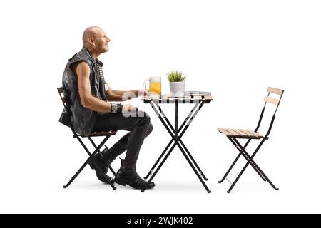 Punk con una pinta di birra al tavolo di un caffè isolato su sfondo bianco Foto Stock